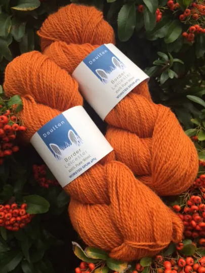 Jervaulx DK yarn skeins, warm pumpkin shade of orange