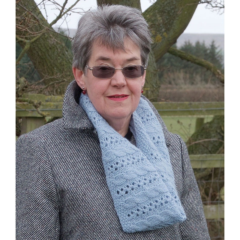 Woman wearing a knitted cable and lace cowl