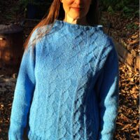Woman wearing woolen sweater knitting kit made from border leicester yarn
